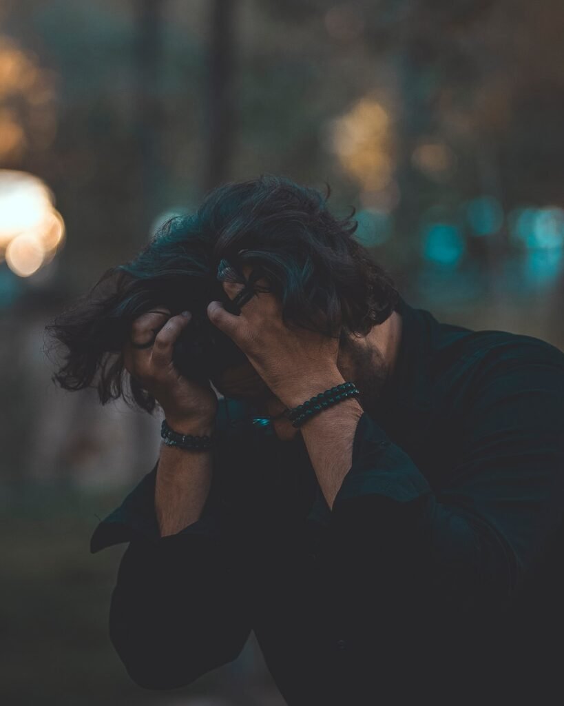 a person with the hands on the face